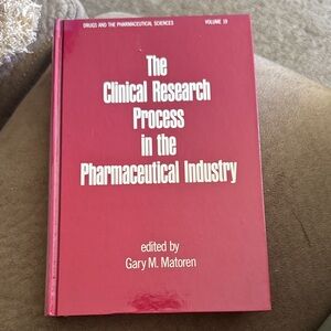 Red Hardcover Book on Clinical Research
